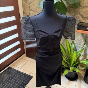 Elegant Black Dress with Sheer Polka Dot Sleeves